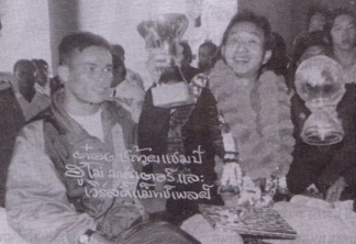 Wattana holding two trophies of 1992 Humo Master and World Matchplay